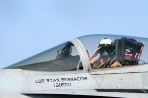 An aviator salutes before take off at sea.